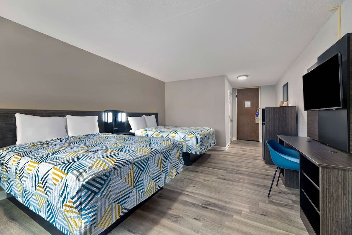 Premium bedding, desk, laptop workspace, blackout drapes