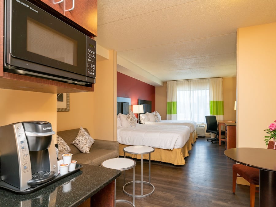 Premium bedding, desk, laptop workspace, blackout drapes