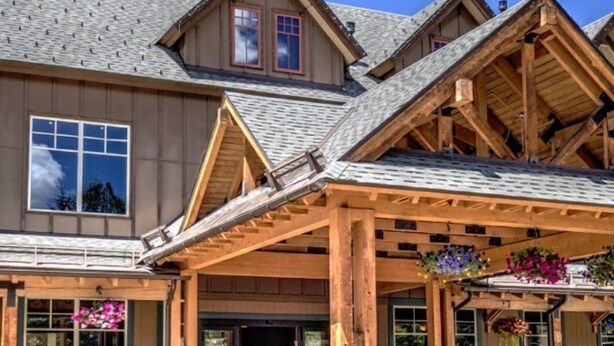 A large wooden building with a covered entrance area, multiple windows, and a stone foundation. - 1 Bedroom Mountain View Condo Located in Historic Downtown Breckenridge Close to Shopping, Dining, Night Life (Breckenridge)