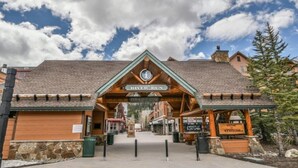 A wooden building with a sign reading "River Run Information Center" and "Welcome to River Run." - 2 Bedroom Colorado Mountain Vacation Rental in River Run Village With Hot Tub Access and Walking Distance to Ski (Keystone)