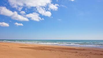 Una spiaggia con cielo sereno e mare calmo.
