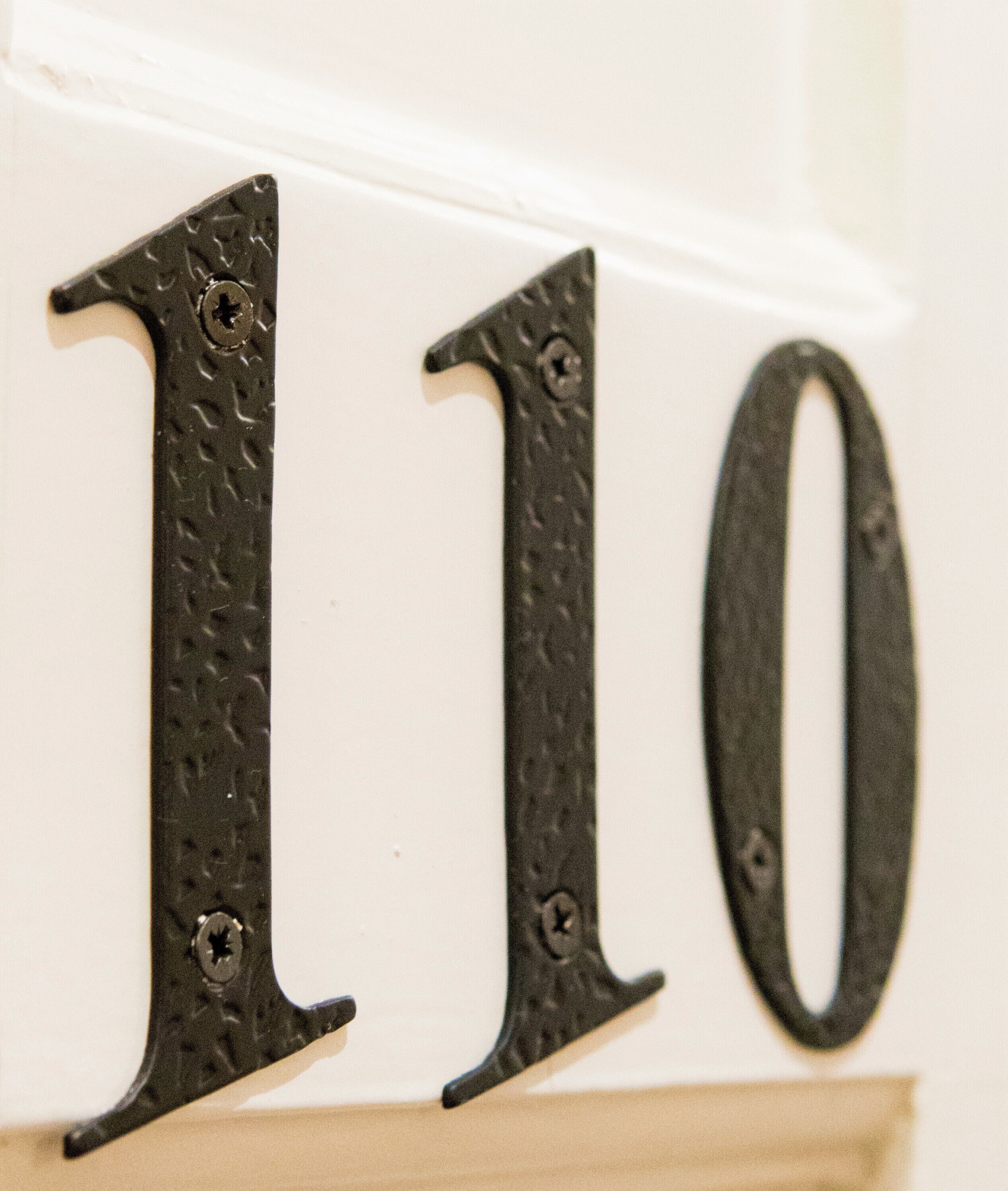 A close-up of a metal sign with the numbers 110.