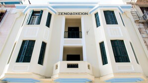 A building with a central balcony and multiple windows with shutters. - Athens Psiri Hotel (Athens)