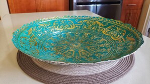 A decorative teal and gold bowl on a woven mat. - I Heart JA Serdos (Tower Isle)