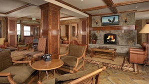 A spacious lobby with a stone fireplace, wooden furniture, and a large mirror. - Premier 2 Bedroom Ski in, Ski out Lone Eagle Condo With the Best Access to Skiing in Keystone (Keystone)