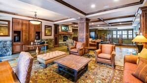 A spacious lobby with leather sofas, a coffee table, and a fireplace. - Premier 4 Bedroom Ski in, Ski out Lone Eagle Condo With the Best Access to Skiing in Keystone (Keystone)