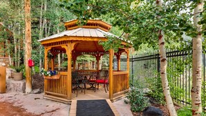 A wooden gazebo with a tiled floor and a black mat in front. - 2 Bedroom Colorado Vacation Rental situated in River Run Village Steps from the Summit Express Gondola (Keystone)