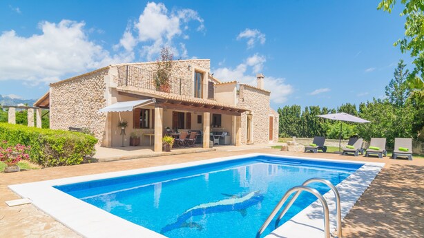 A house with a swimming pool, stone exterior, and outdoor seating area. - FINCA MIRALLES - Villa with private pool in Búger. Free WiFi (Búger)