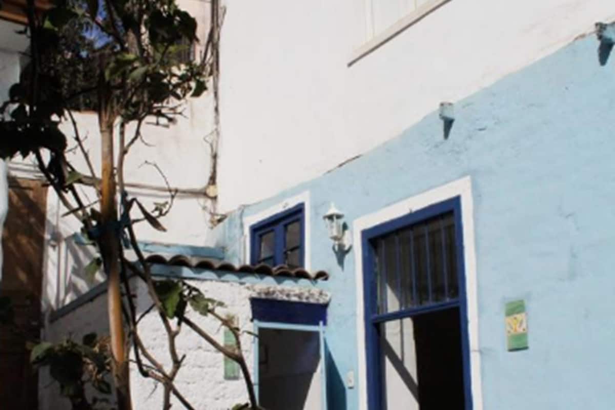 A building with a blue exterior, a door, and a window.