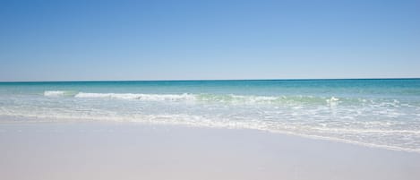 A beach with clear skies and calm waves.