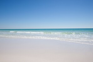 A beach with clear skies and calm waves.