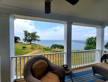 Porch & view from upper Master Bedroom. Couch, chair, adirondack table & chairs.