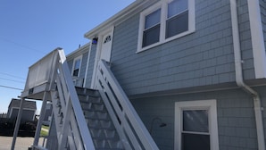 A two-story house with a visible staircase and a window. - "THE PLACE AT SUNRISE BEACH" (Marshfield)