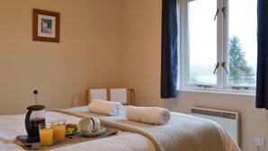 A hotel room with a bed, a tray with breakfast items, a picture on the wall, and a window with curtains. - 2 bedroom accommodation in Arduaine, near Oban (Arduaine, near Oban)