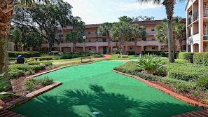 Enjoy a round of golf in our serene courtyard, surrounded by lush hedges and palm trees.