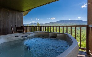 A hot tub on a balcony with a mountain view.
