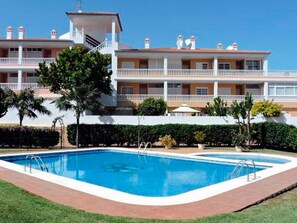 A hotel with a swimming pool, multiple balconies, and a well-maintained garden. - Casa Manuela - Holidays like in your own home. (Puerto de la Cruz)