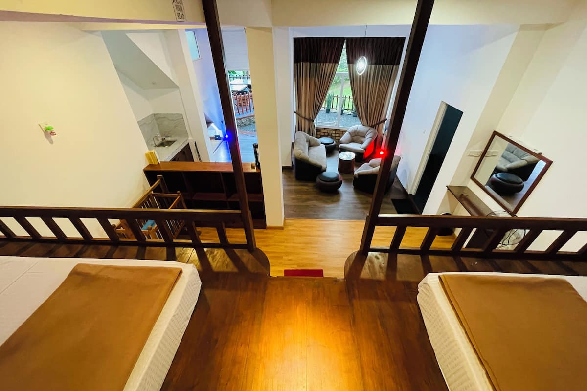 Une chambre avec deux lits, un bureau, une chaise, un canapé et une télévision.