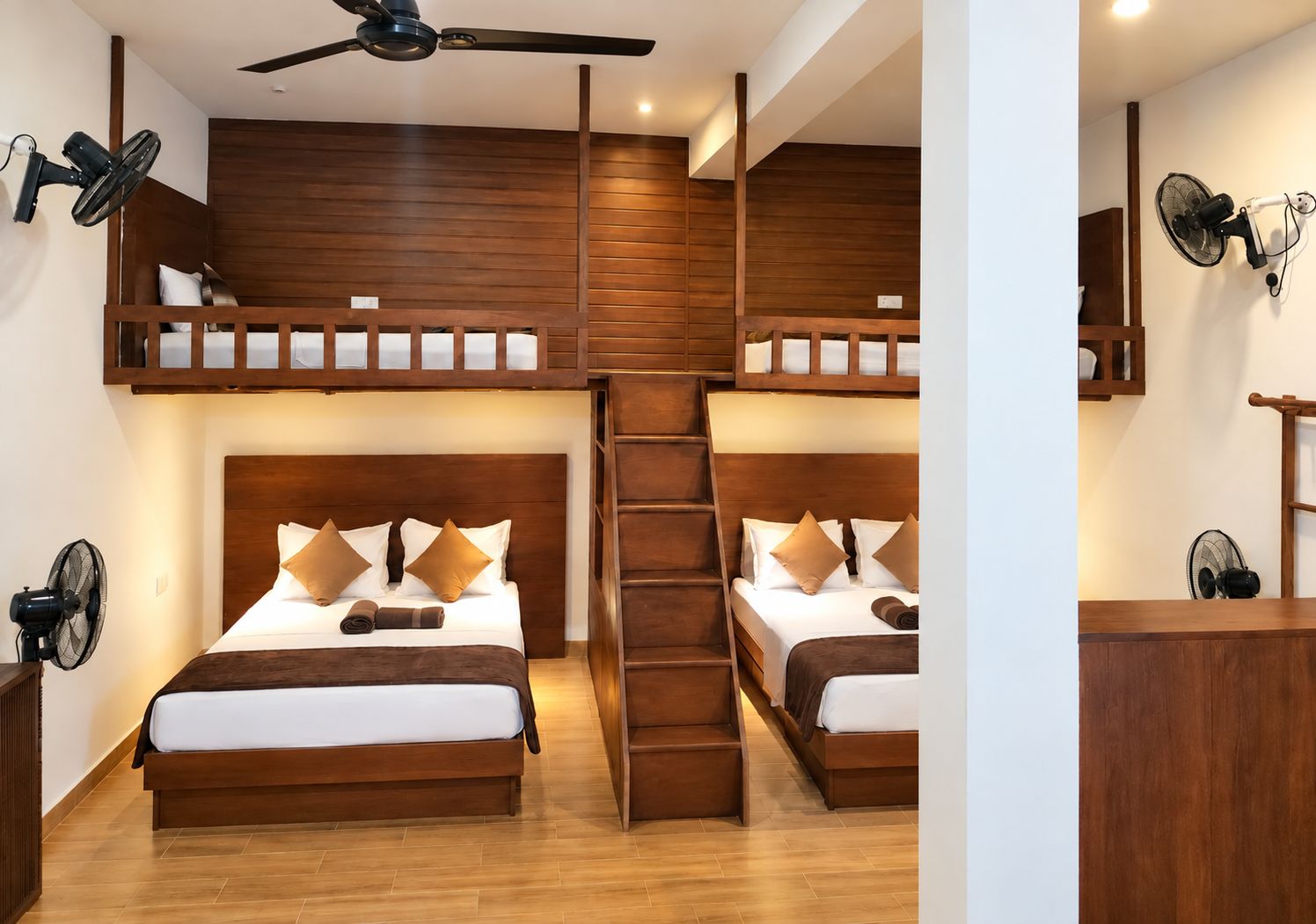 A room with two bunk beds, a ceiling fan, and a wooden ladder.