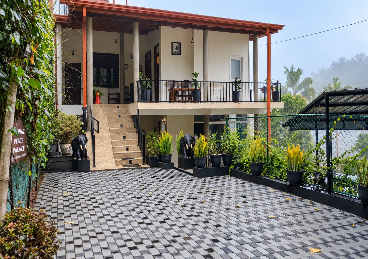 A two-story building with a checkered floor pattern, a balcony with potted plants, and a staircase leading to the upper level.