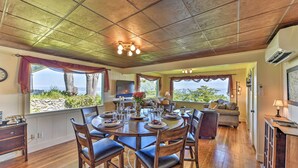 A dining area with a round table, chairs, and a view of the outdoors. - Waterfront Home ~ 6 Mi to Olympic National Park! (Port Angeles)