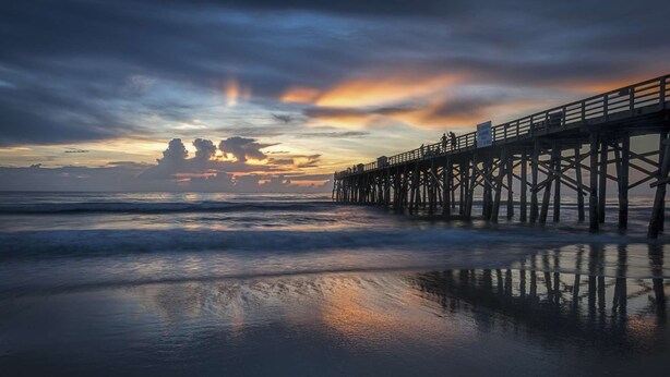 A pier extending into the ocean with a sunset in the background. - Pelican Suite | Bombora Suites | Steps To Flagler Beach & Restaurants (Flagler Beach)
