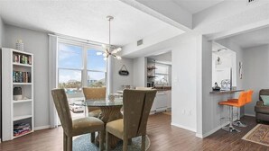 A modern interior with a dining area, kitchen, and living space. - Pelican Suite | Bombora Suites | Steps To Flagler Beach & Restaurants (Flagler Beach)