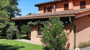A two-story house with a tiled roof and a chimney. - Casa Riva by Interhome (Figino)