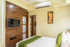 Economy Room | Minibar, in-room safe, desk, laptop workspace - Super Inn Armoise Hotel (Ahmedabad)