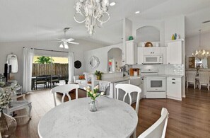 Enjoy meals in the kitchen with a dining area and round table.