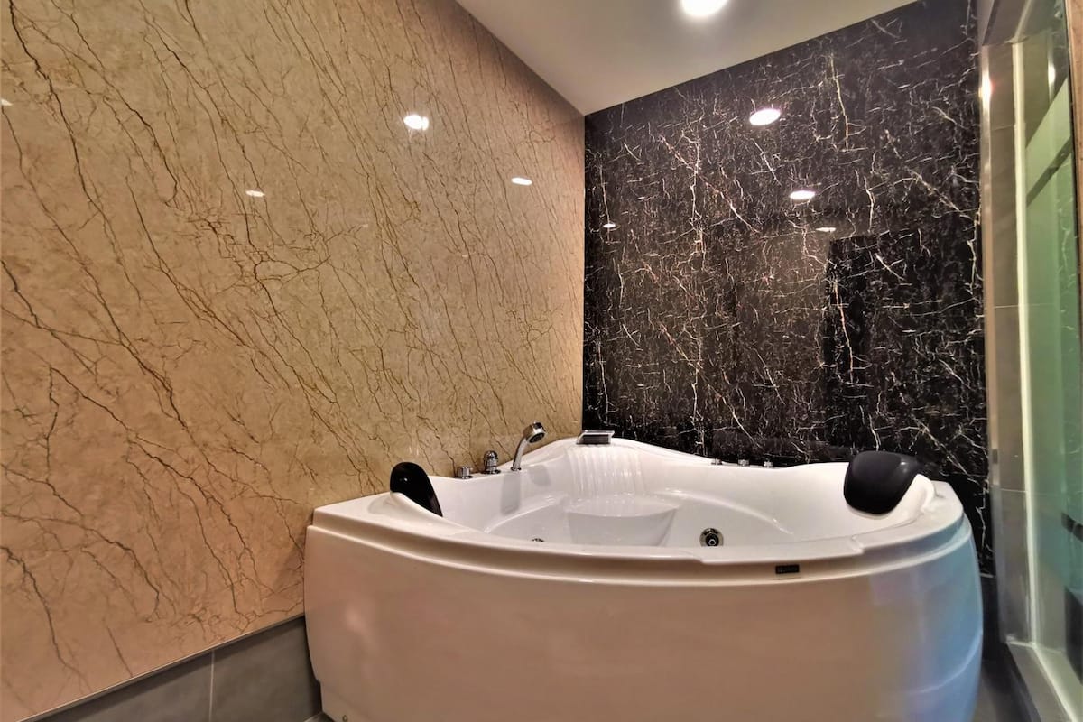 shower, hair dryer, slippers, towels