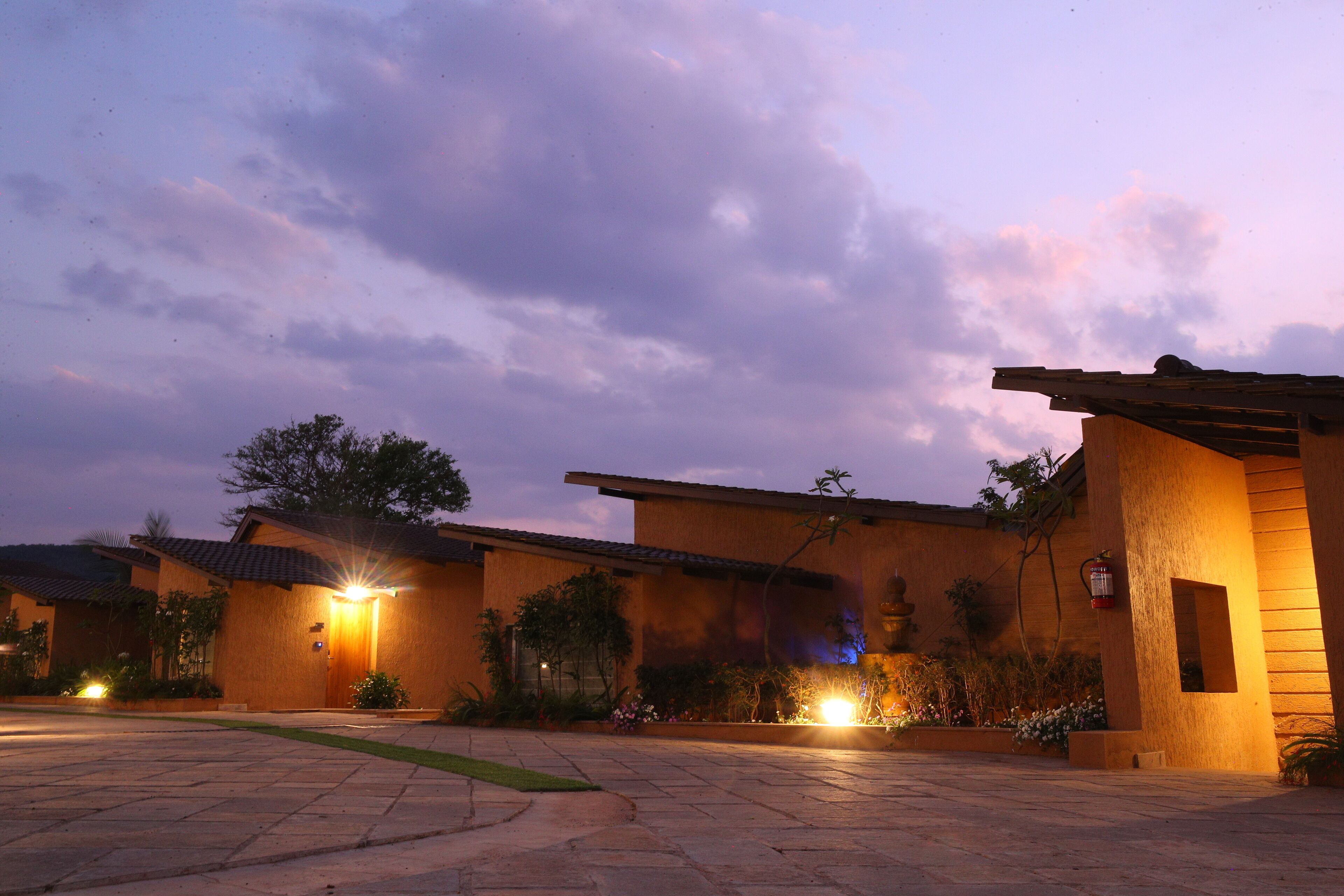 A building with a tiled roof and a well-lit entrance.