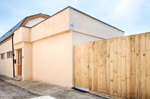 A building with a wooden fence, a door, and a sign indicating the number 72A. - The Nook Close to Swansea Marina (Swansea)