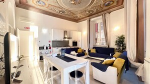 A modern living room with a dining area, white furniture, and a decorative ceiling. - Casa Rosa al Mare, Rapallo, Silver (Rapallo)