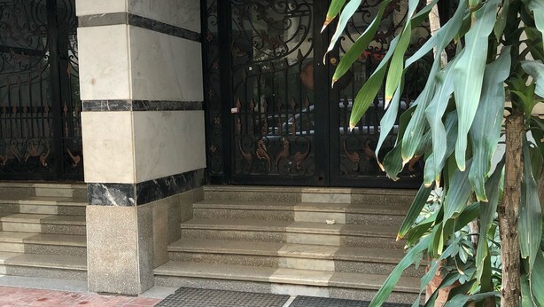 A building entrance with a marble staircase, a metal gate with decorative patterns, and a potted plant. - A Cosy Three Bedrooms  Apartment in Degla, Maadi ,Cairo, Egypt. (Maadi)