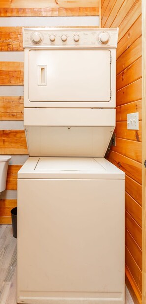 A compact, white, two-door appliance with a control panel on top, likely a washer and dryer, in a wooden-paneled room. - Gigantic Views GSMNP/3.6 Miles 2 DwTn Gatlinburg (Gatlinburg)