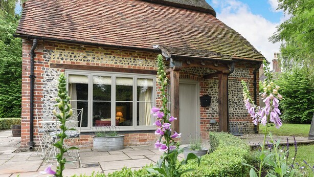 A brick building with a window, a door, and a small porch. - 2 bedroom accommodation in Cheriton (Cheriton)