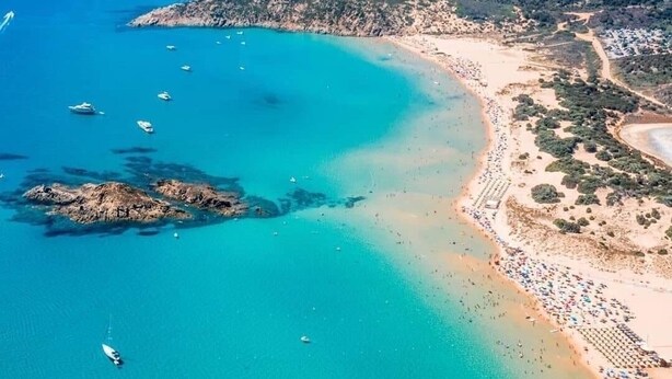 An aerial view of a coastal area with a beach, boats, and a mountainous landscape. - Refined detached villa for nature lovers. (Domus De Maria)