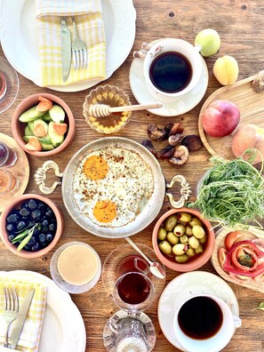 A breakfast setting with various food items and drinks. - Alacati Barbarossa Hotel (Cesme)