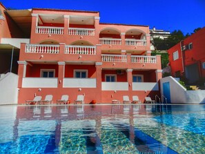 A multi-story hotel with a pool in front. - Paradiso Aparthotel (Corfu)