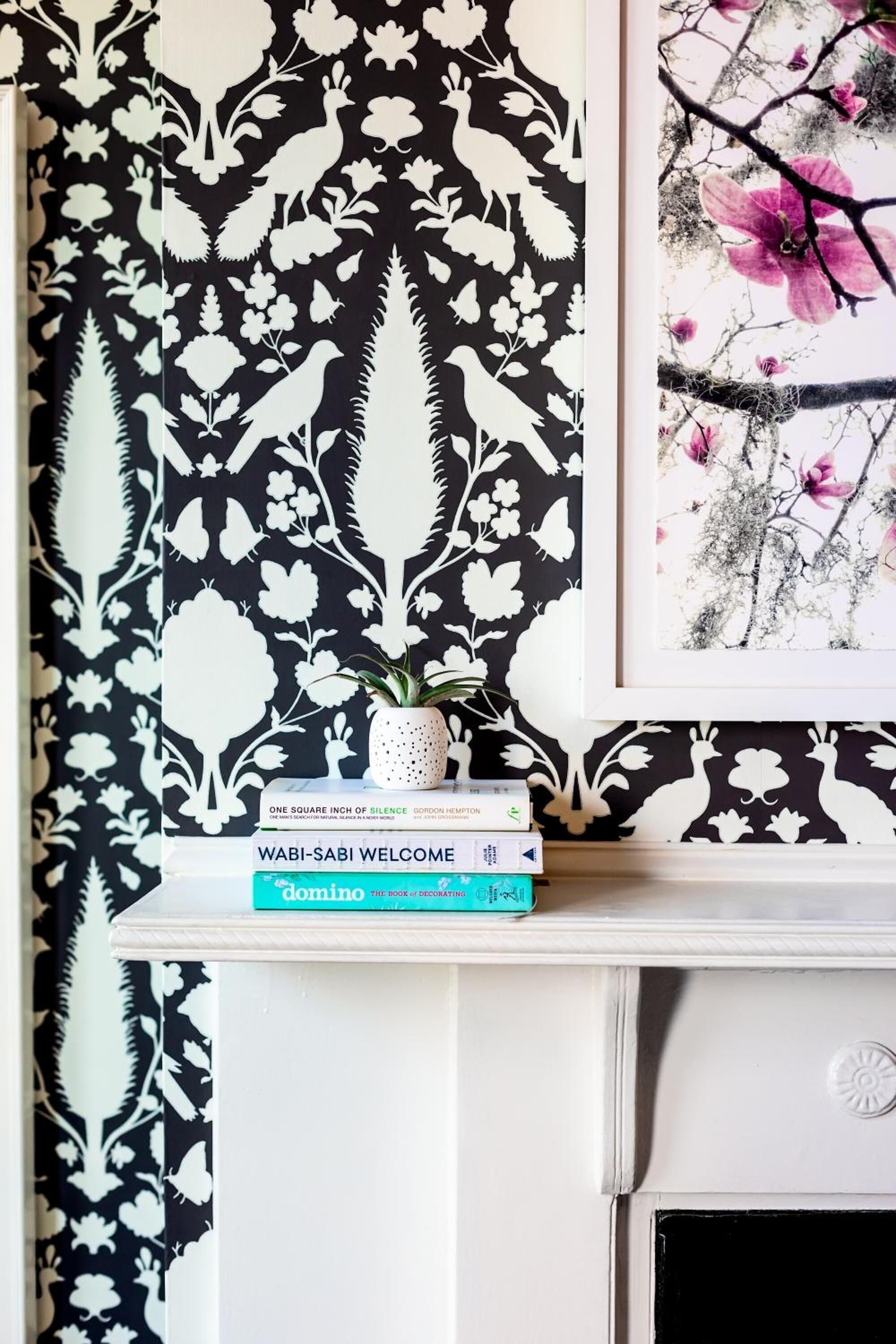 A bookshelf with books and a framed picture.