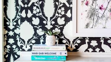 A bookshelf with books and a framed picture.