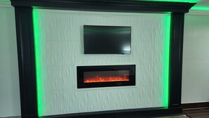 A fireplace with a flat-screen TV above it, set in a textured wall.