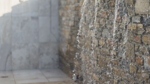 A stone wall with a water feature. - Virginia Luxury Villas (Samos)