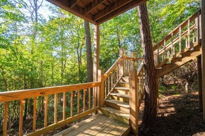 A wooden staircase leading up to a covered area surrounded by trees. - The Nest at Innsbruck| 2 BR| Golf Community and Amenities (Helen)