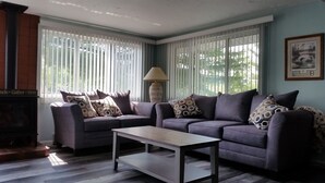 A living room with two sofas, a coffee table, and a lamp. - LAKEFRONT COTTAGE  (Lake George)