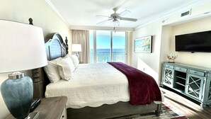 A hotel room with a large bed, a ceiling fan, a TV, and a view of the ocean. - MVG 1112 3 Bedroom 3 Bath Oceanfront (North Myrtle Beach)
