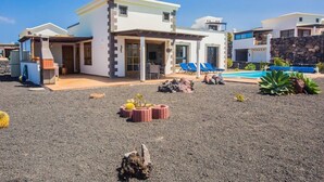 A modern house with a pool, outdoor seating, and a garden. - Villa Eleonor in Playa Blanca (Playa Blanca)