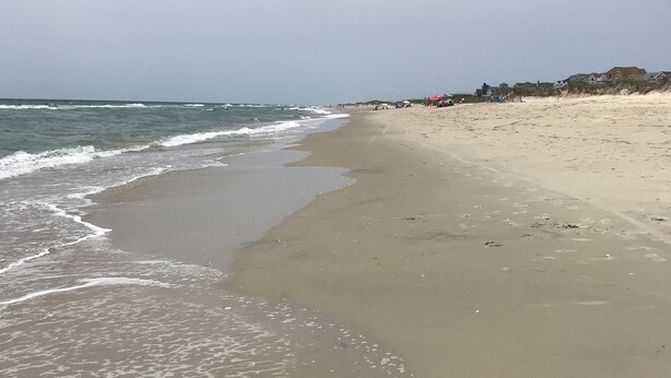 A beach with a sandy shore and waves. - In The Heart of Hatteras Village. Close to Beach, Restaurants and Marinas. (Hatteras)