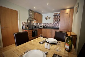 Enjoy cooking and dining in this well-equipped kitchen with oven, microwave, and gas stove.